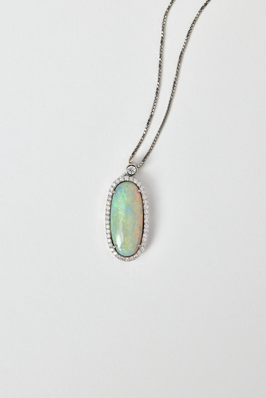 solid opal pendant with halo diamonds in 18ct white gold