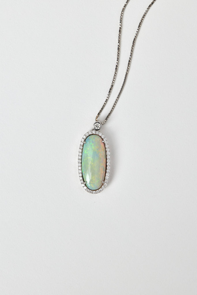 solid opal pendant with halo diamonds in 18ct white gold