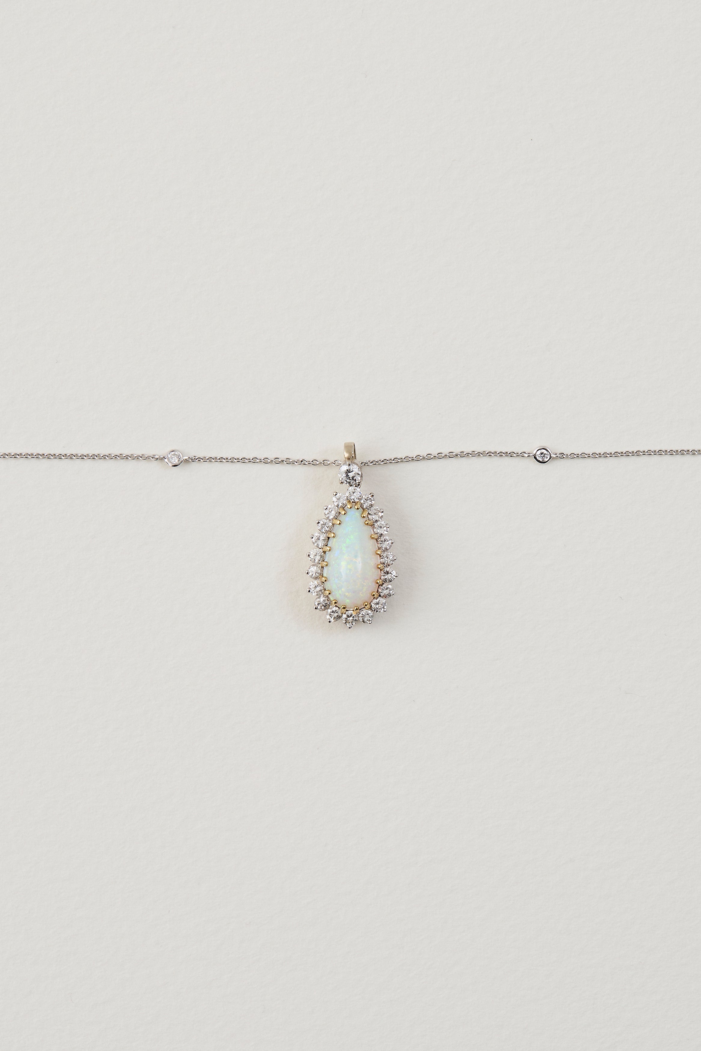 solid opal necklace surrounded by diamonds from lighing ridge available at keshett