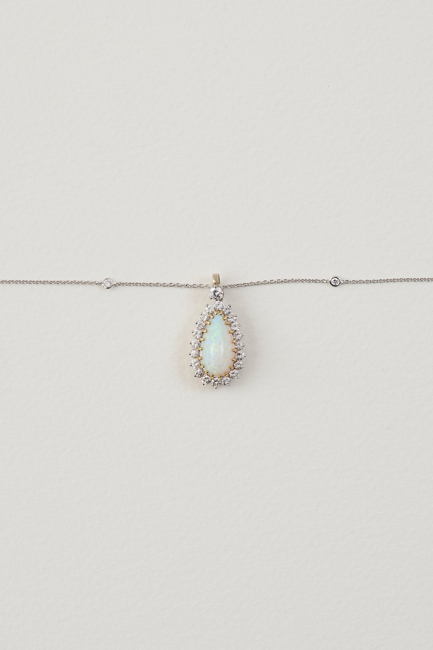 solid opal necklace surrounded by diamonds from lighing ridge available at keshett
