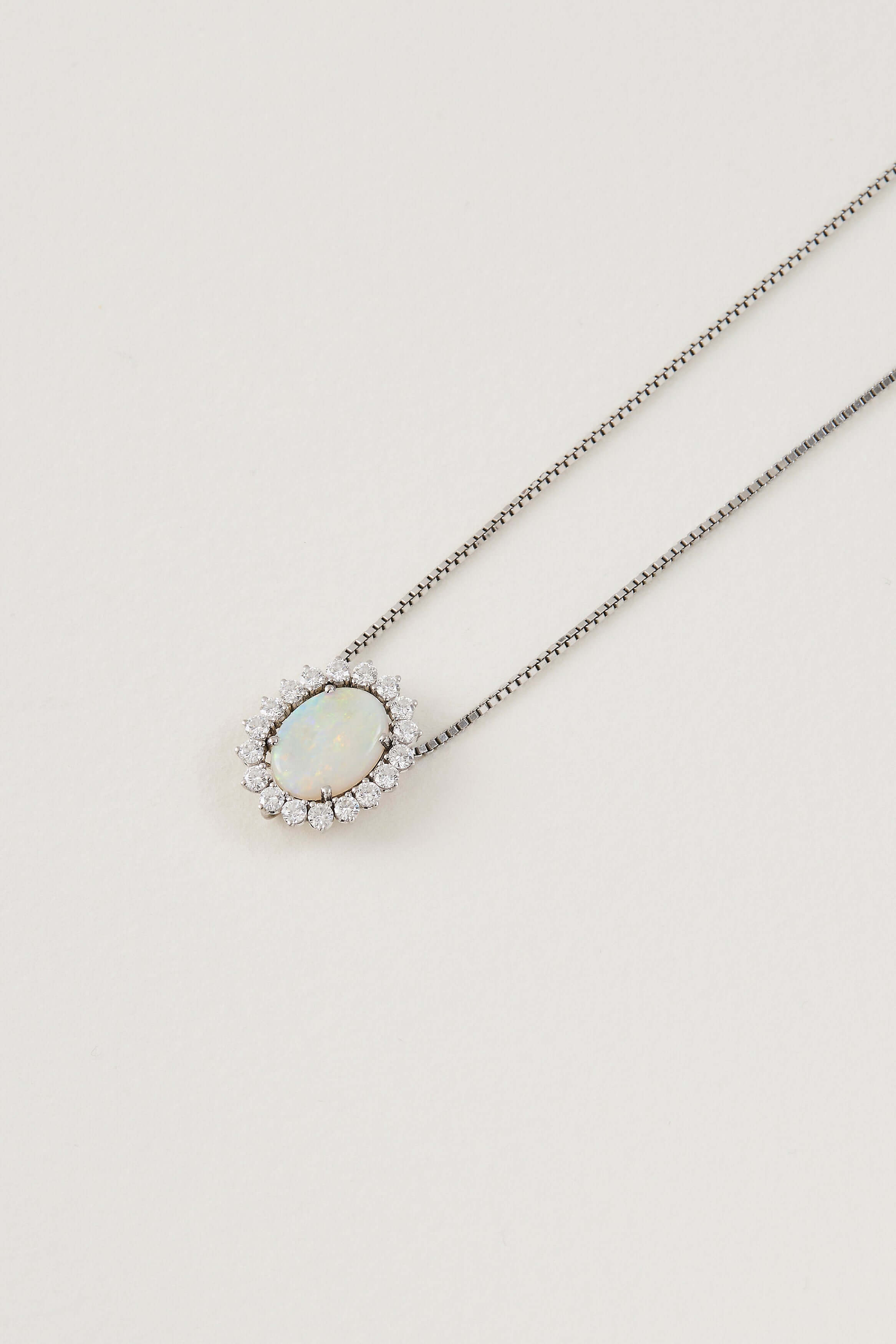 solid opal necklace surrounded by diamonds from lighing ridge available at keshett