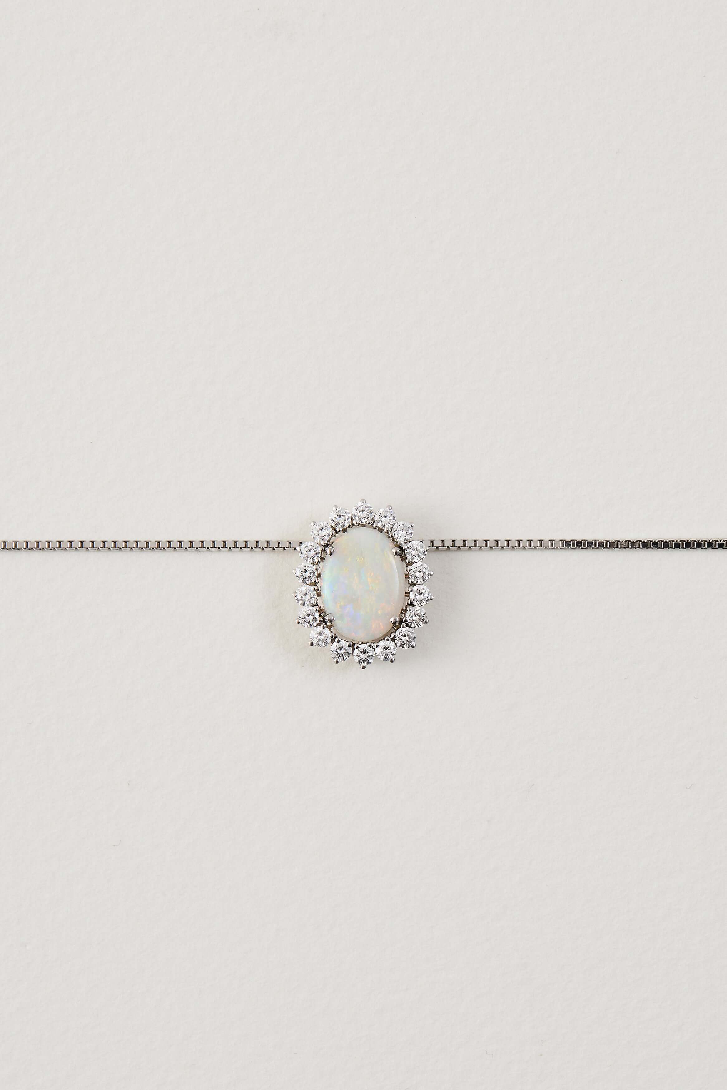 solid opal necklace surrounded by diamonds from lighing ridge available at keshett