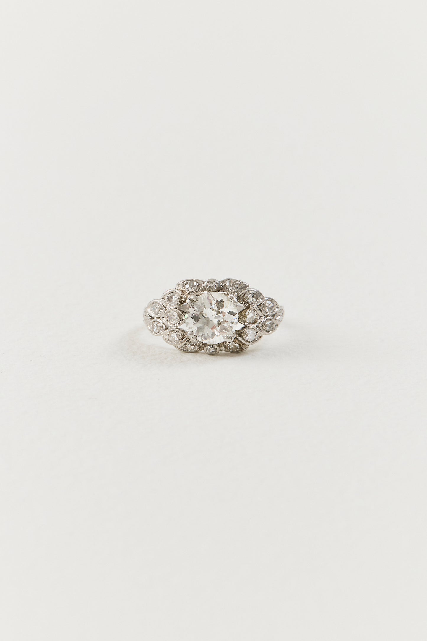  Showcasing a luminous 1.10 carat old European-cut diamond at its centre, the ring unfolds in an elongated navette-shaped composition, its softly curved borders tracing the outline of the centre diamond with considered grace. Sixteen single-cut diamonds are arranged in a flowing, organic framework around the centre stone, each one bezel-set and carefully placed to follow the natural r