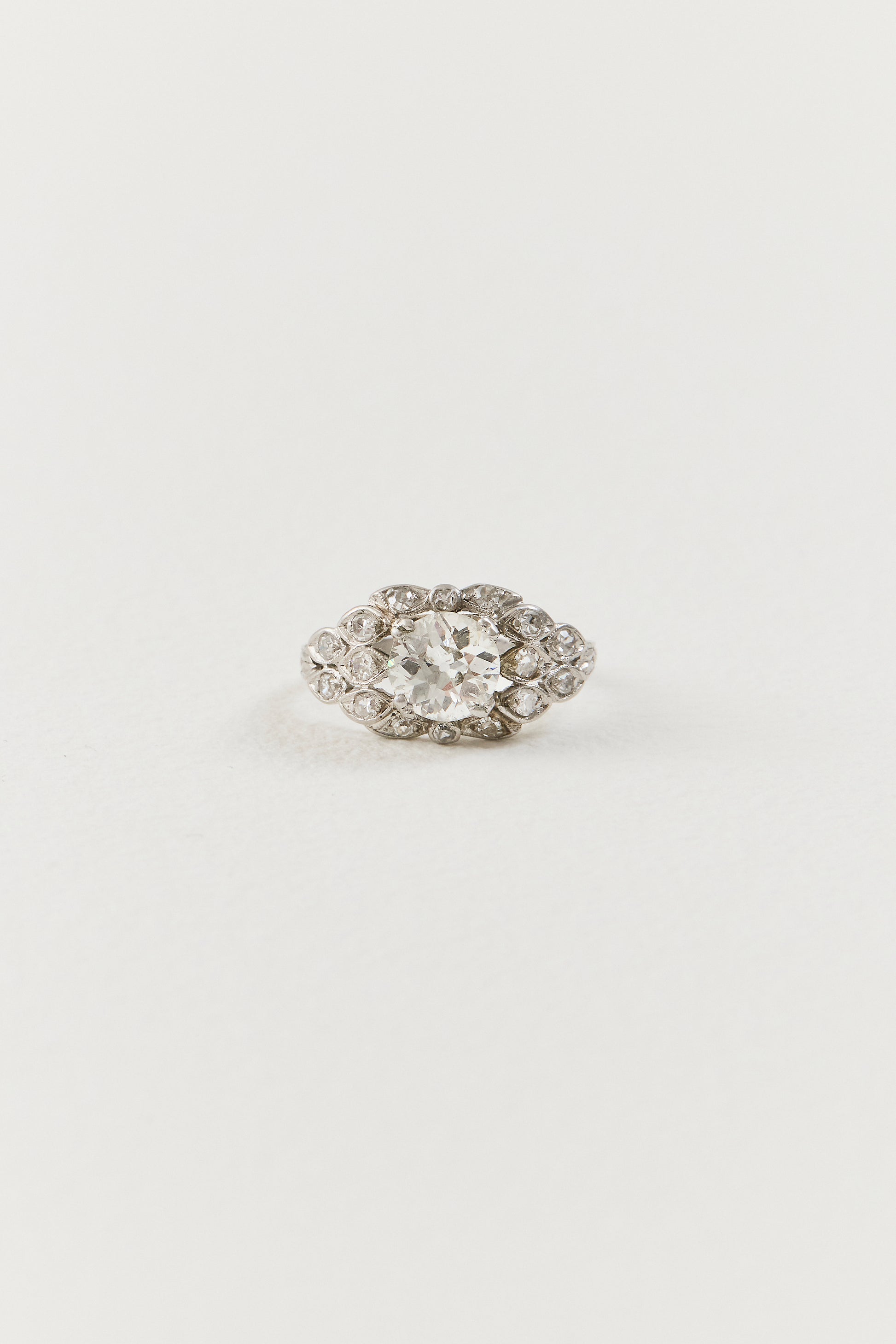  Showcasing a luminous 1.10 carat old European-cut diamond at its centre, the ring unfolds in an elongated navette-shaped composition, its softly curved borders tracing the outline of the centre diamond with considered grace. Sixteen single-cut diamonds are arranged in a flowing, organic framework around the centre stone, each one bezel-set and carefully placed to follow the natural r