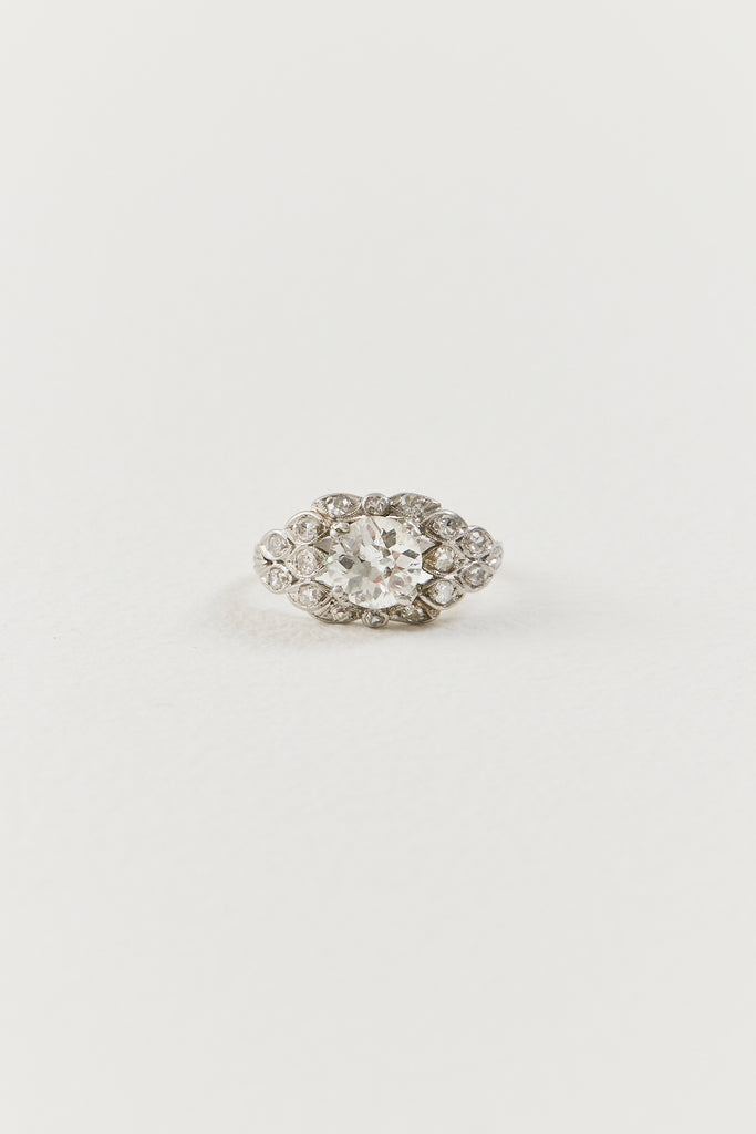  Showcasing a luminous 1.10 carat old European-cut diamond at its centre, the ring unfolds in an elongated navette-shaped composition, its softly curved borders tracing the outline of the centre diamond with considered grace. Sixteen single-cut diamonds are arranged in a flowing, organic framework around the centre stone, each one bezel-set and carefully placed to follow the natural r